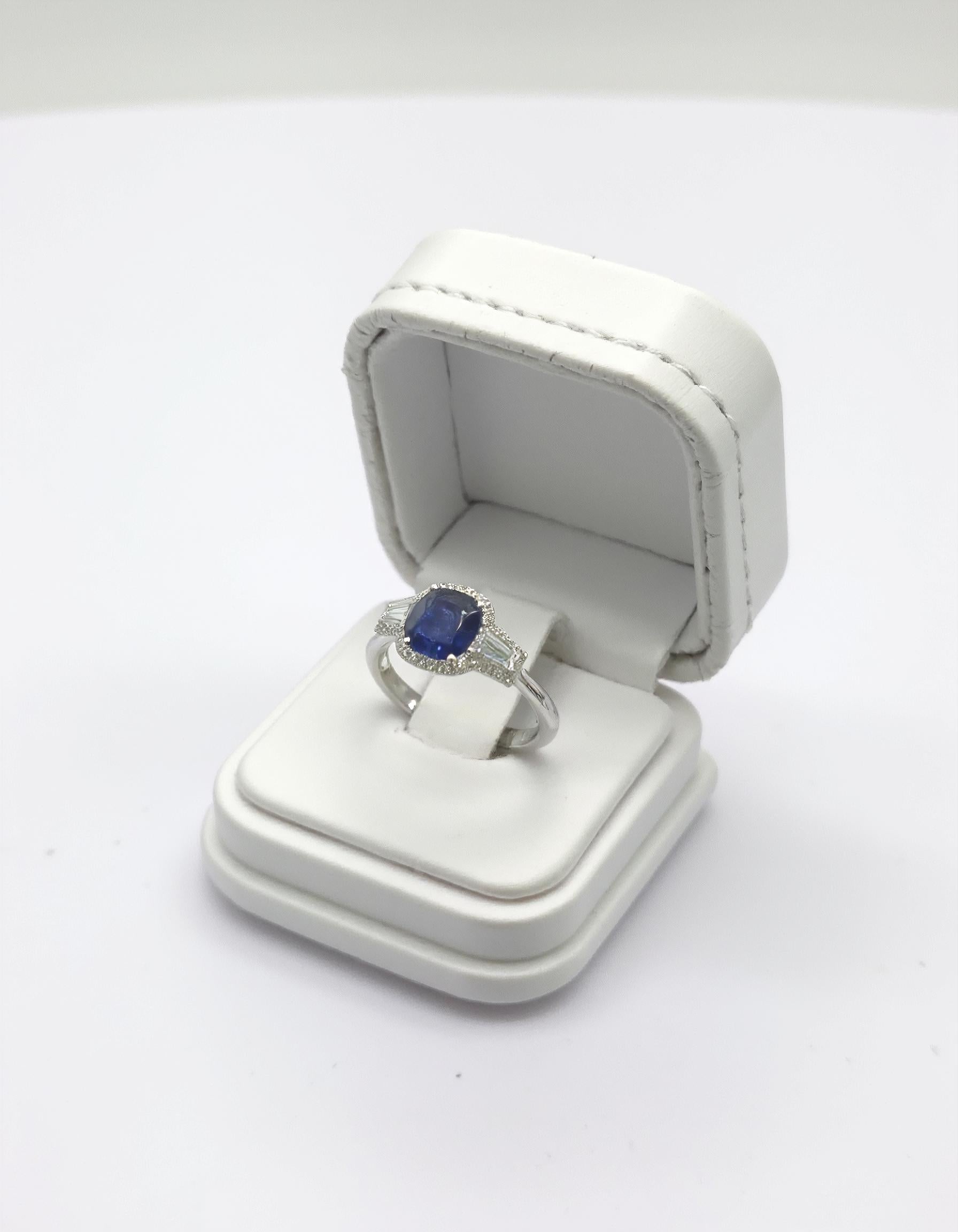 "Lirine" Cushion cut Blue Sapphire with tapered baguette Diamonds with an Halo Ring