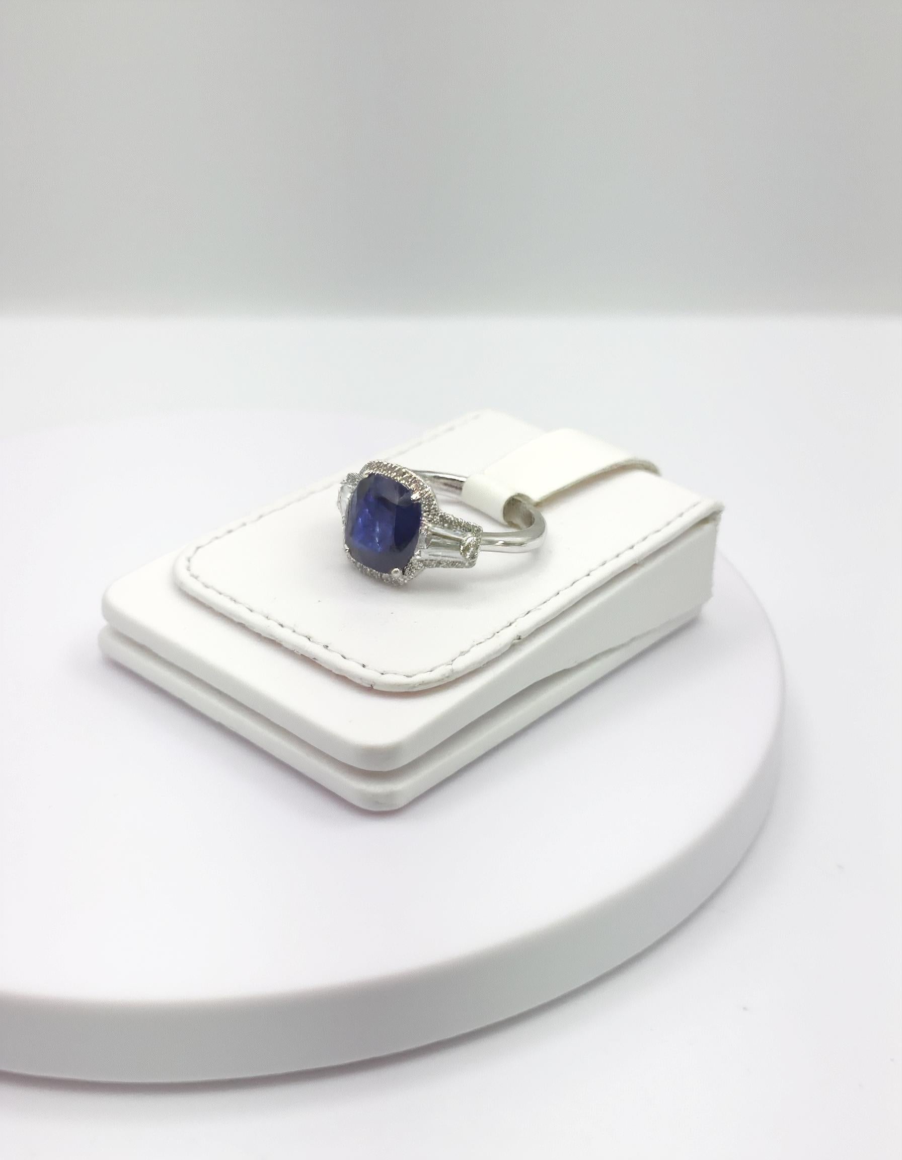 "Lirine" Cushion cut Blue Sapphire with tapered baguette Diamonds with an Halo Ring