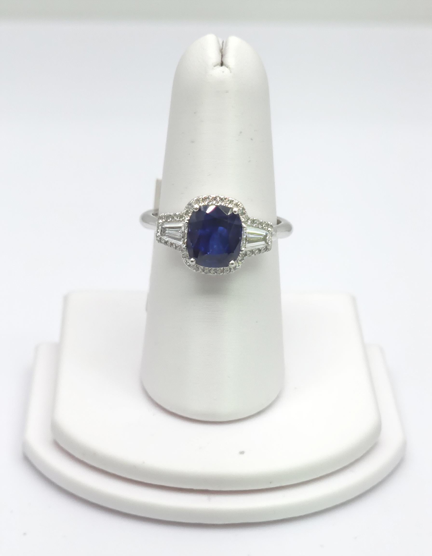 "Lirine" Cushion cut Blue Sapphire with tapered baguette Diamonds with an Halo Ring