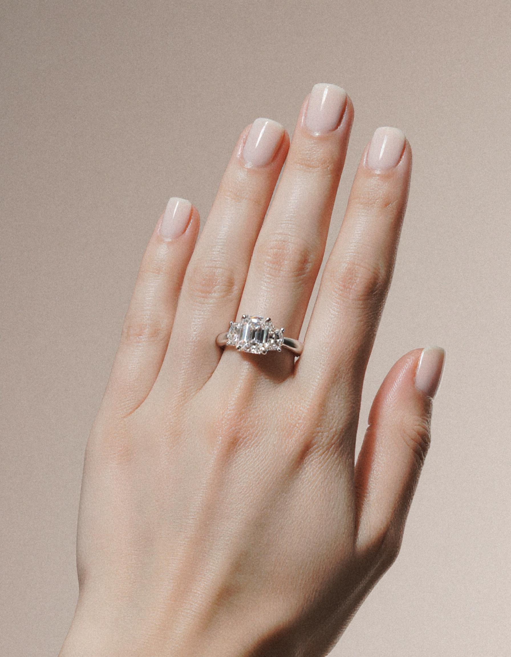 "Ivara" 3 stone Diamond ring With Emerald cut center and Cadillac cut side stones