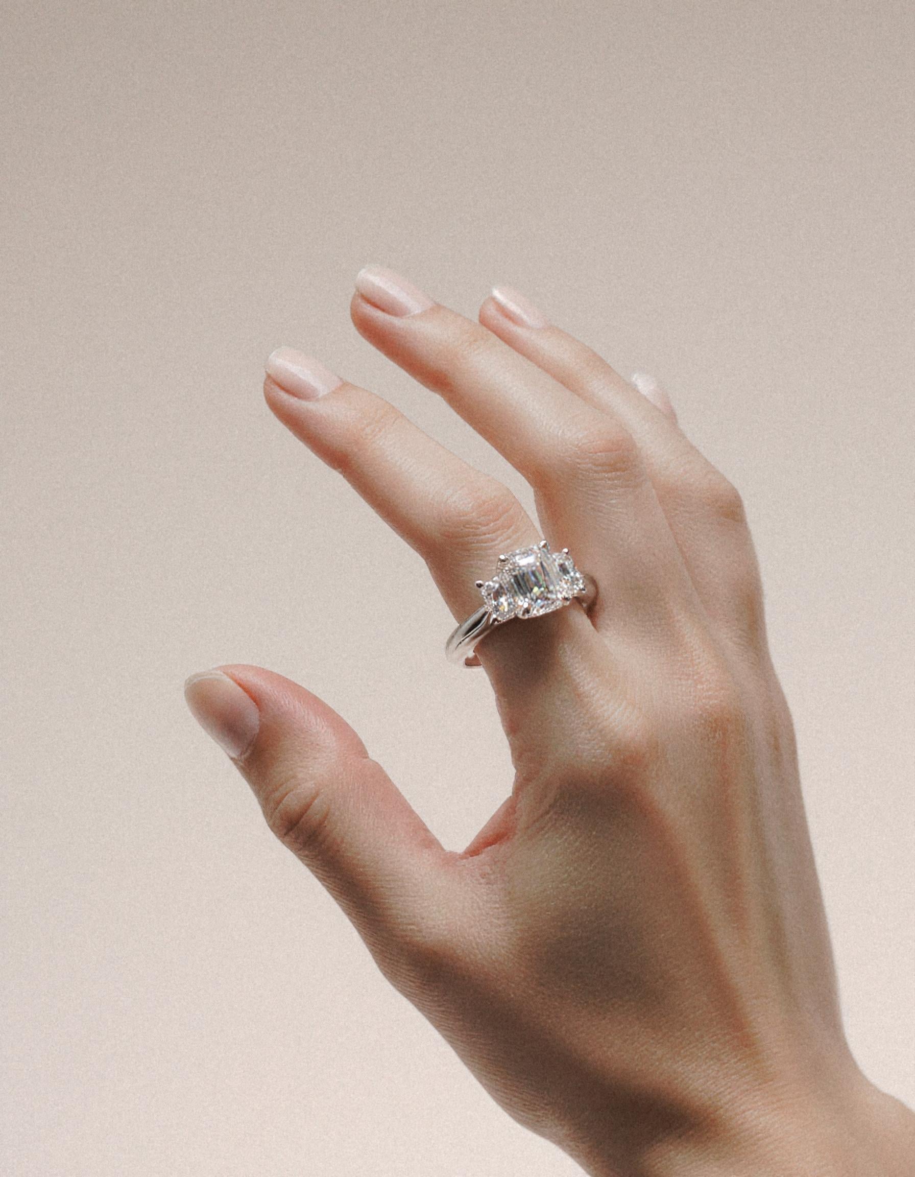 "Ivara" 3 stone Diamond ring With Emerald cut center and Cadillac cut side stones