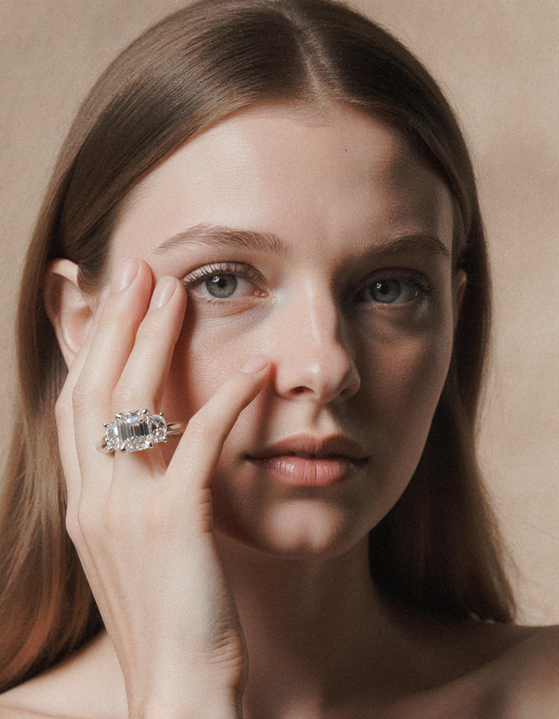 "Ivara" 3 stone Diamond ring With Emerald cut center and Cadillac cut side stones