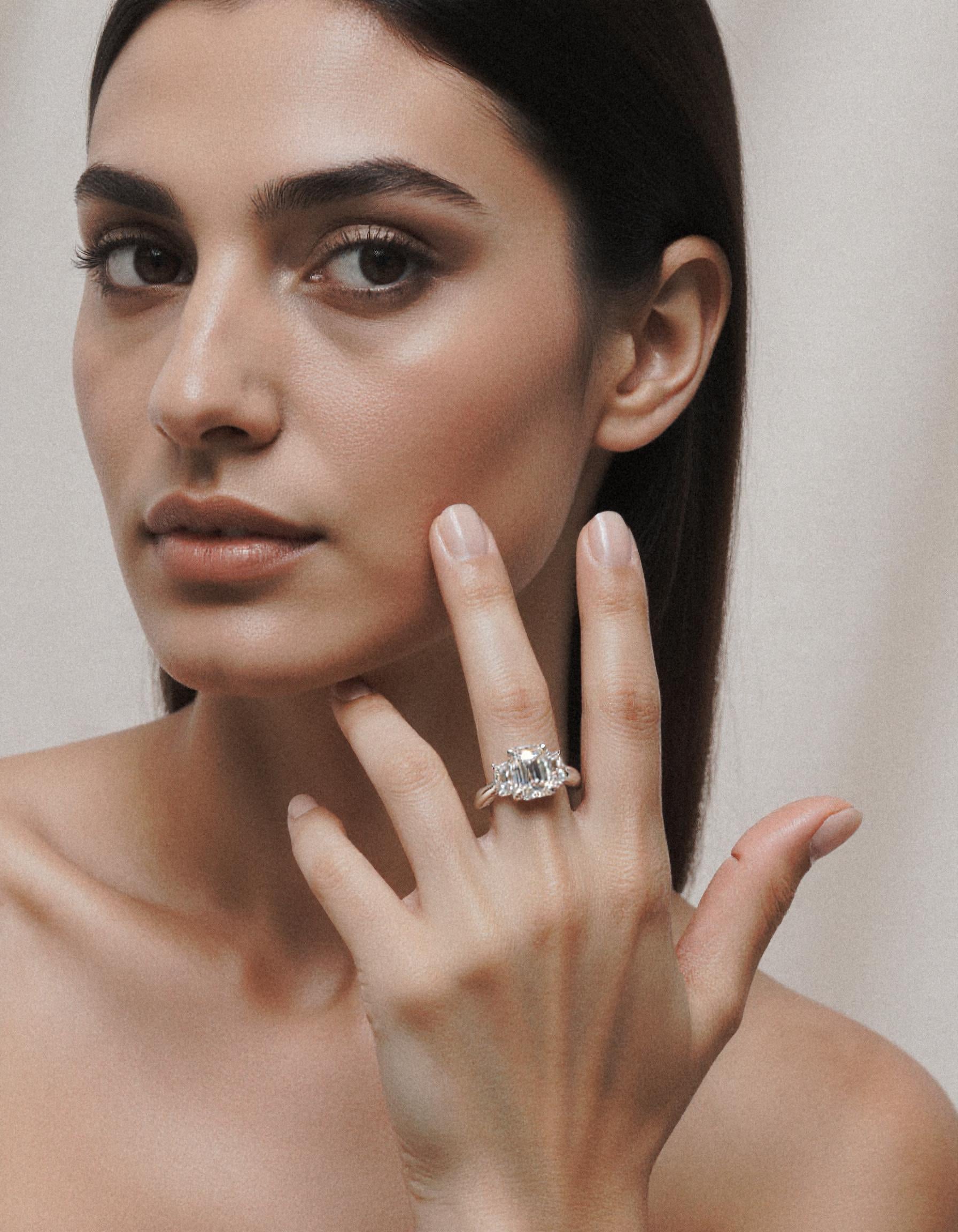 "Ivara" 3 stone Diamond ring With Emerald cut center and Cadillac cut side stones