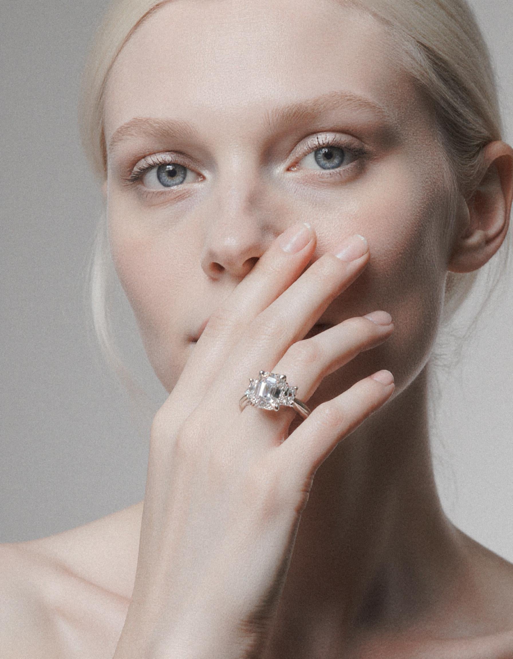 "Ivara" 3 stone Diamond ring With Emerald cut center and Cadillac cut side stones