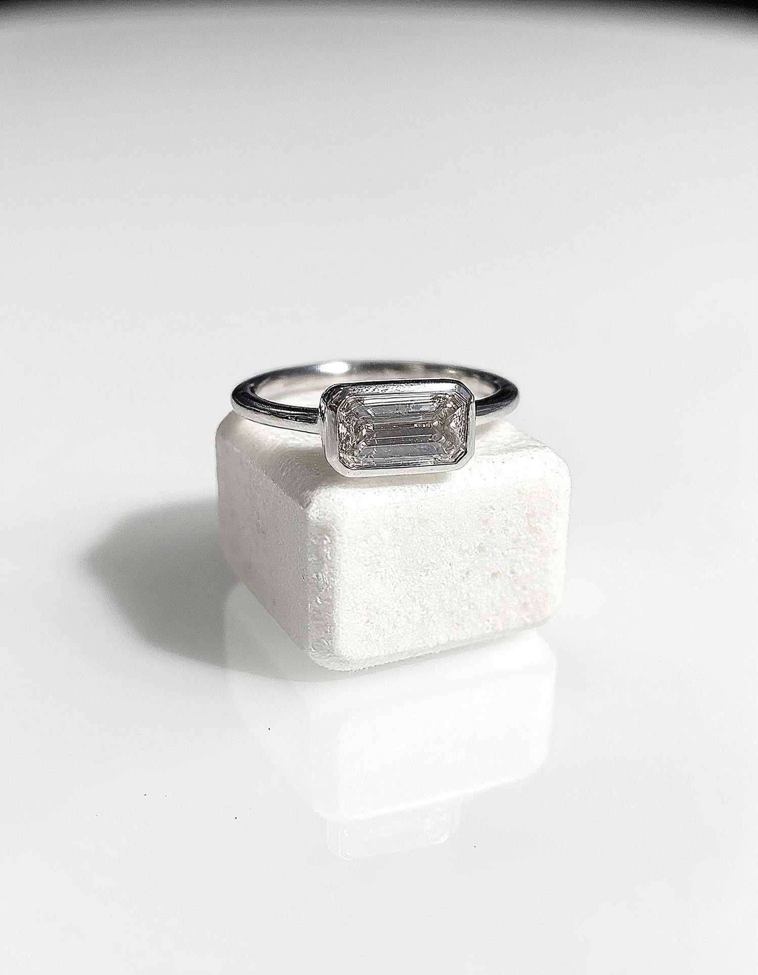 &quot;Lana&quot; Emerald Cut diamond solitaire in Bezel setting set Horizontally