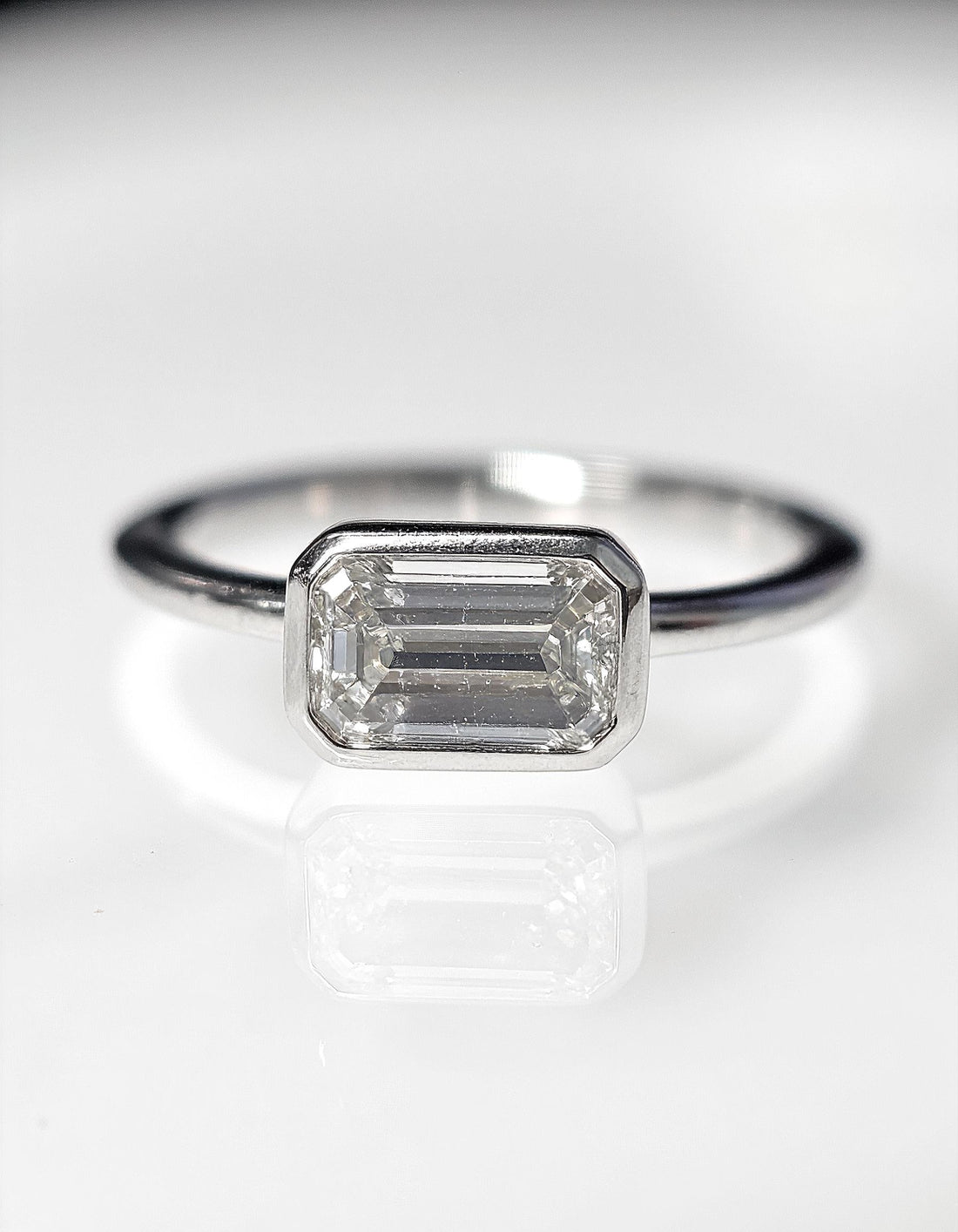 &quot;Lana&quot; Emerald Cut diamond solitaire in Bezel setting set Horizontally