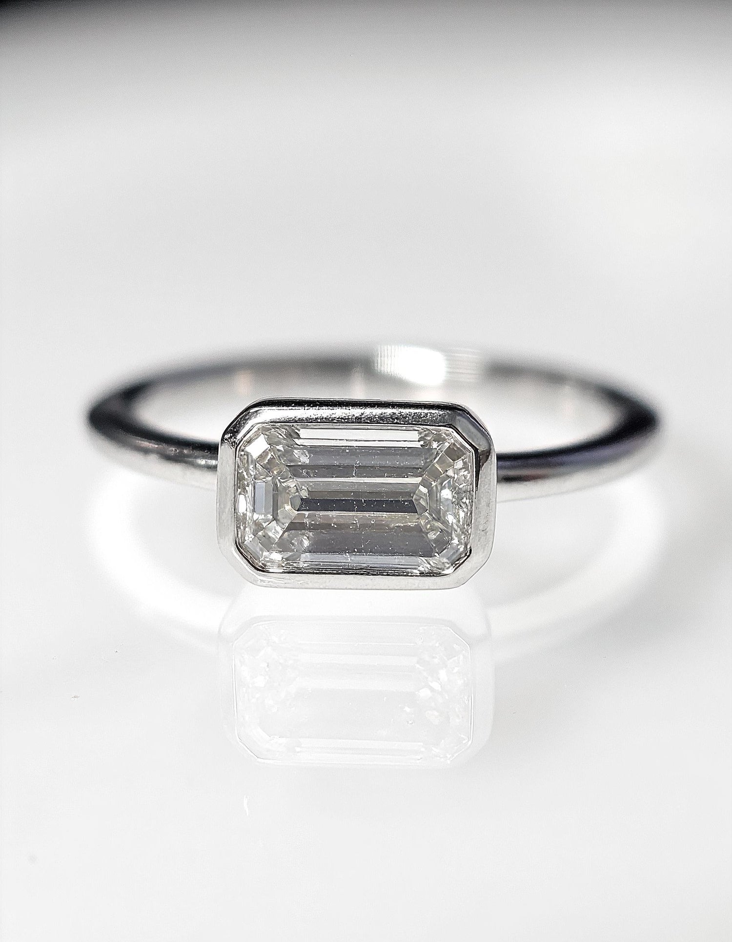 &quot;Lana&quot; Emerald Cut diamond solitaire in Bezel setting set Horizontally