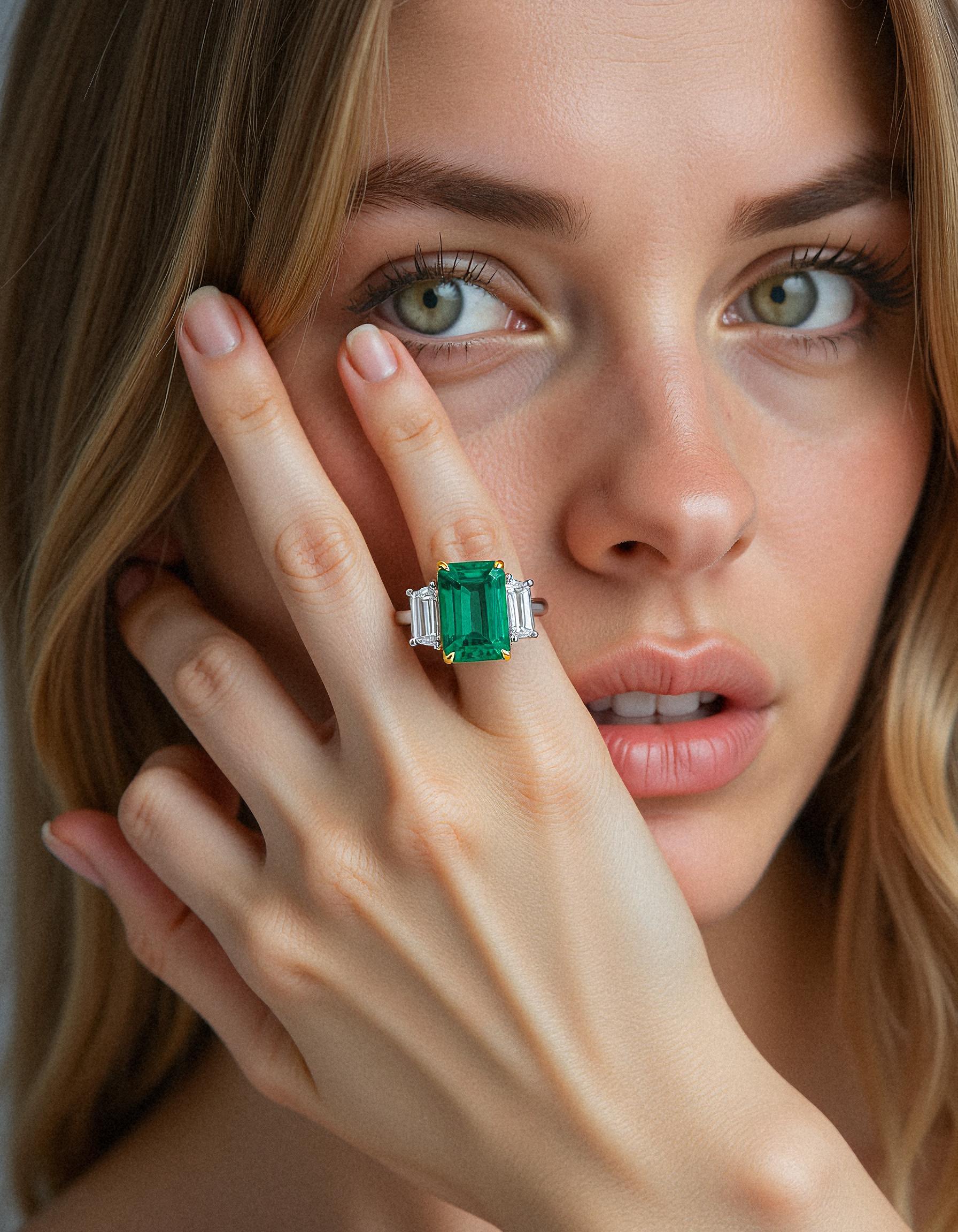 &quot;Abigail&quot; White and yellow gold three-stone ring with an emerald-cut Green emerald center and trapezoid diamond side stones.
