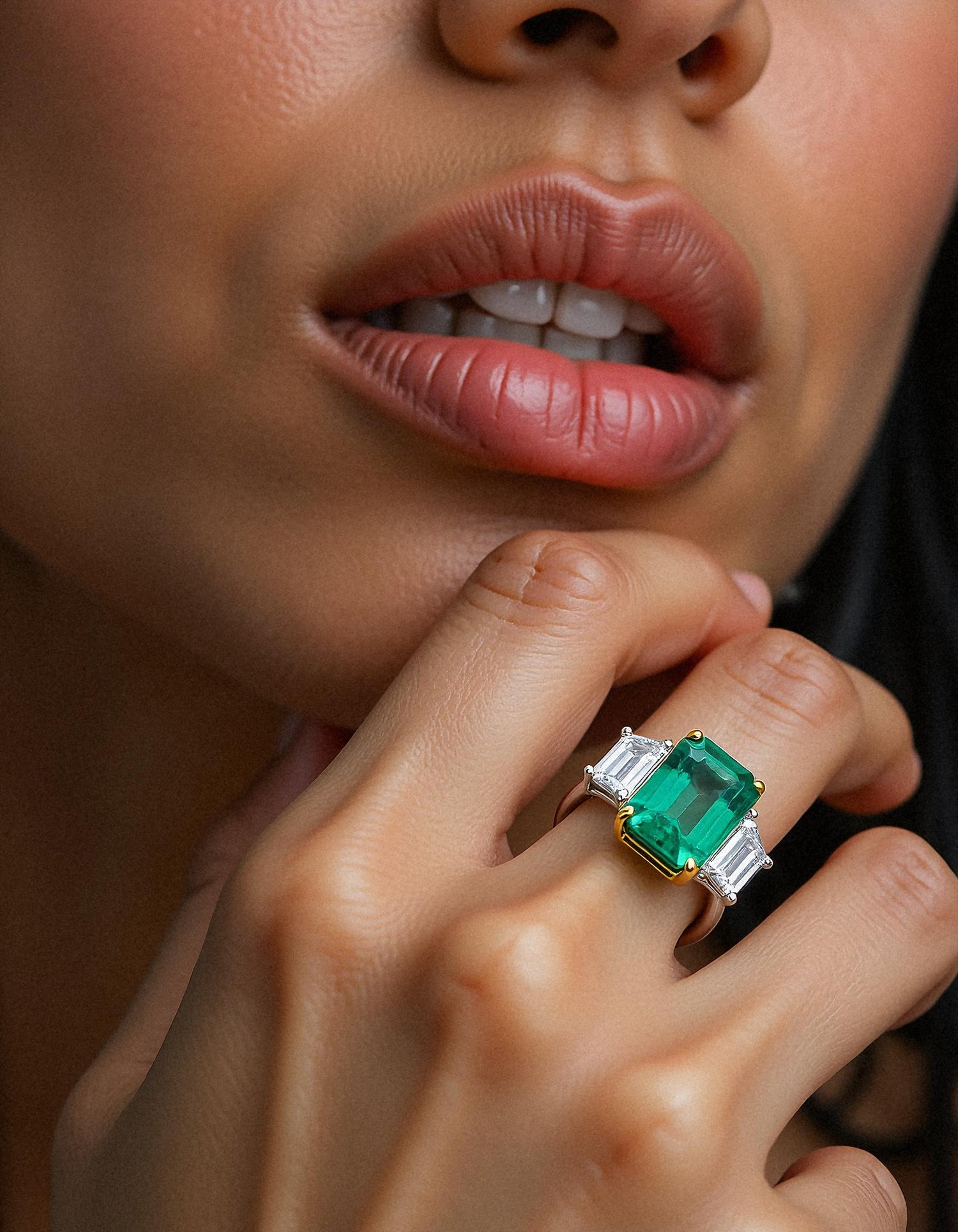 &quot;Abigail&quot; White and yellow gold three-stone ring with an emerald-cut Green emerald center and trapezoid diamond side stones.