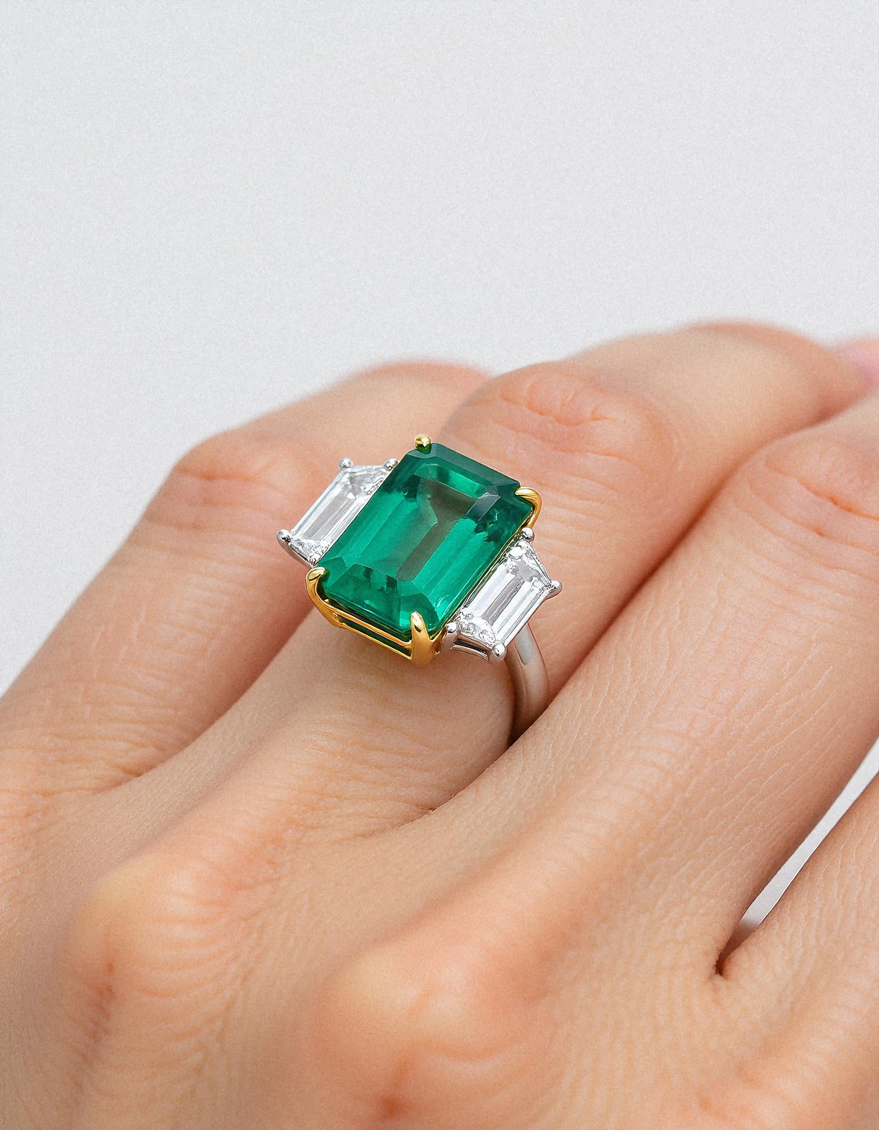 &quot;Abigail&quot; White and yellow gold three-stone ring with an emerald-cut Green emerald center and trapezoid diamond side stones.