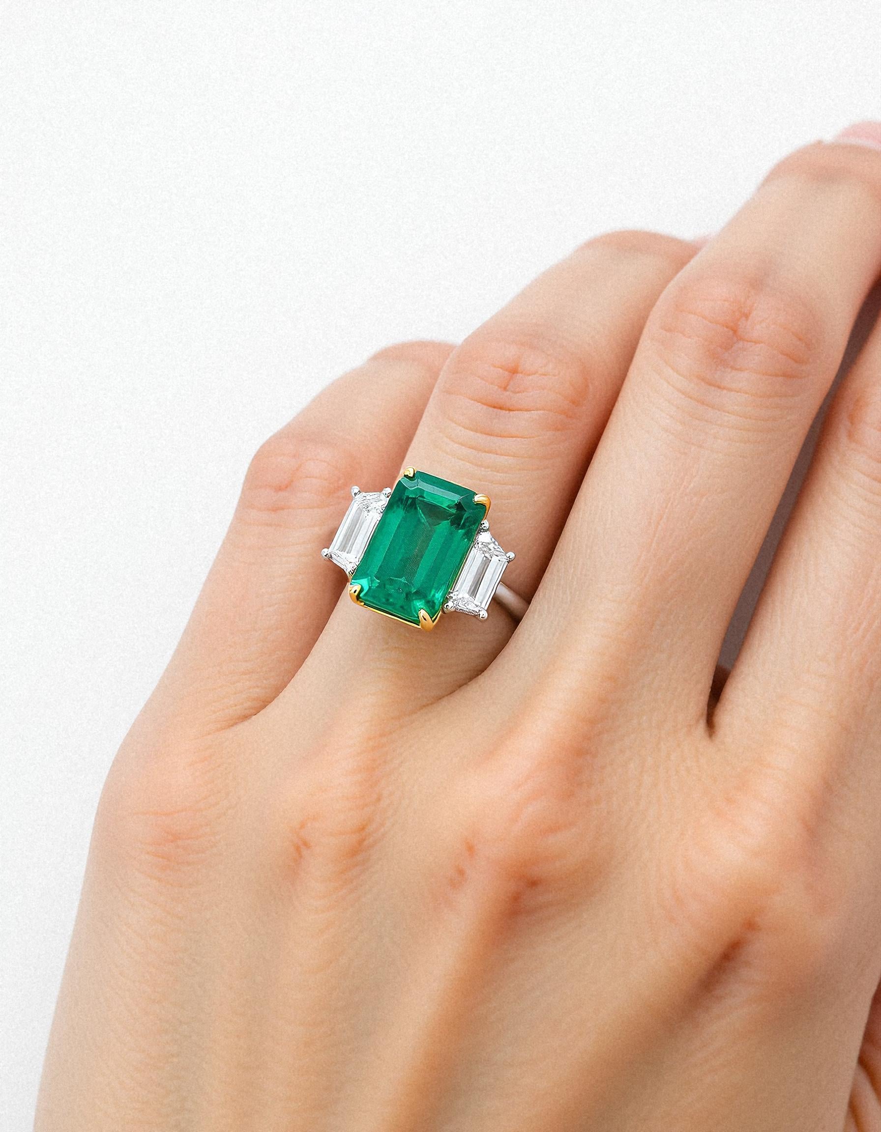 &quot;Abigail&quot; White and yellow gold three-stone ring with an emerald-cut Green emerald center and trapezoid diamond side stones.