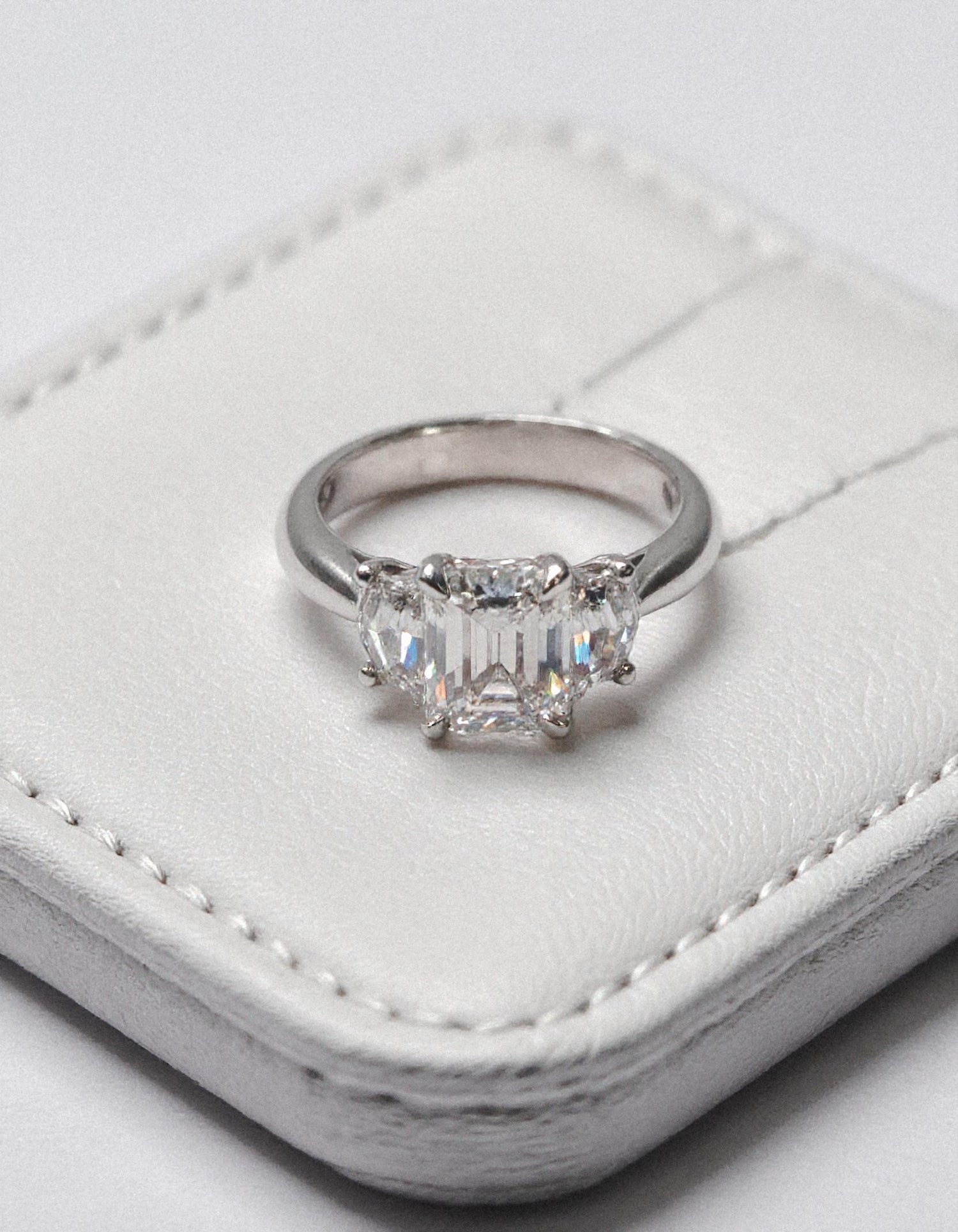 &quot;Ivara&quot; 3 stone Diamond ring With Emerald cut center and Cadillac cut side stones