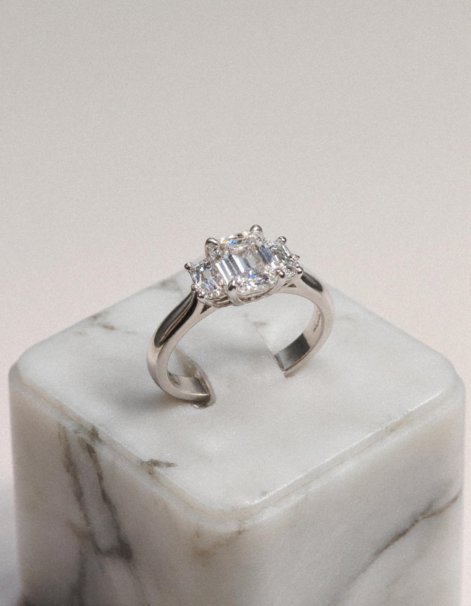 &quot;Ivara&quot; 3 stone Diamond ring With Emerald cut center and Cadillac cut side stones